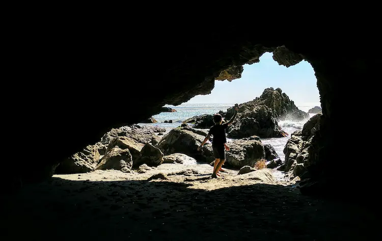 child in cave 1 of 3 caves